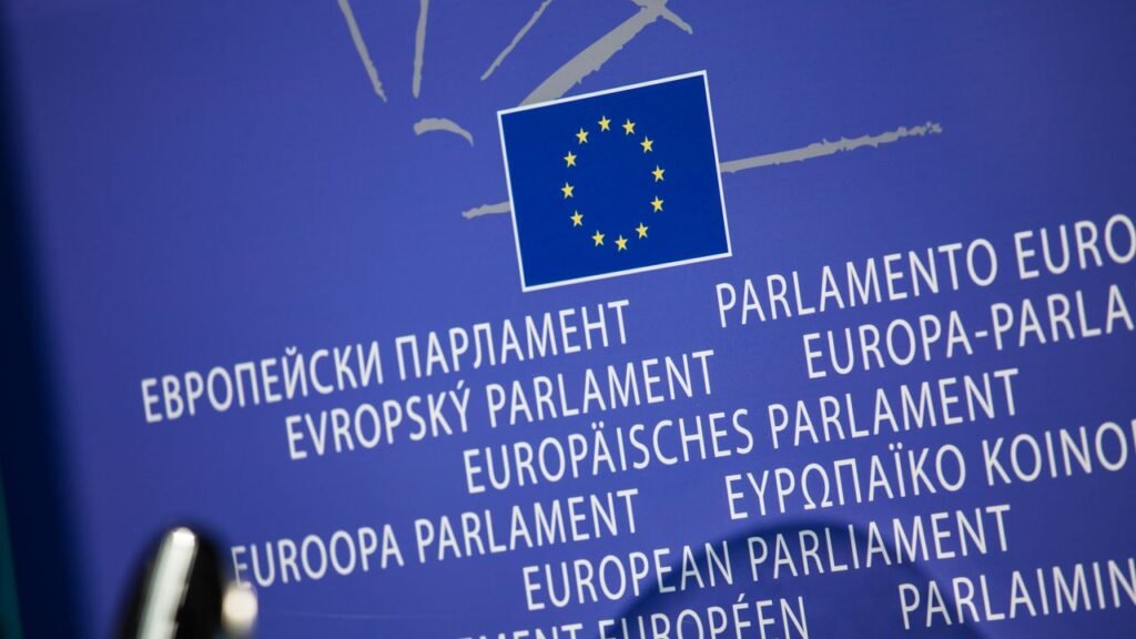 Close-up view of the European Union flag with multilingual text showing European Parliament.