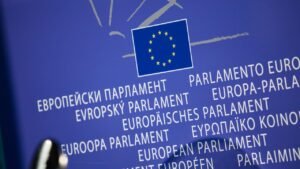 Close-up view of the European Union flag with multilingual text showing European Parliament.