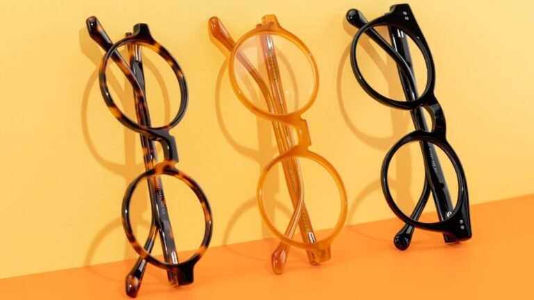 Three stylish eyeglasses arranged on a bright, colorful surface.